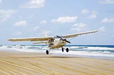 Plane landing on 75-Mile Beach, Fraser Island, Queensland, Australia