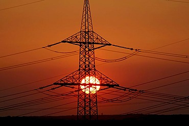 Sunset behind electricity pylon, Ruhr area, Germany, Europe