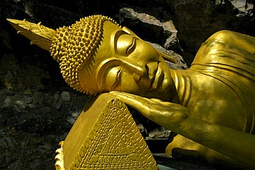 Lying head of the reclining Buddha in the Wat Tham Temple, on Phu Si Mountain, Luang Prabang, Laos, Southeast Asia