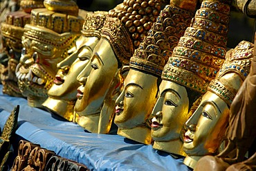 Souvenirs, row of gold painted masks carved out of wood, Indein, Inle Lake, Shan State, Burma, Myanmar, Southeast Asia