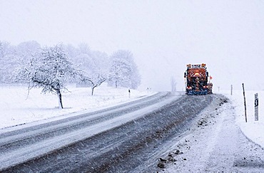 Snow-clearing vehicle clearing snow during strong snowfall