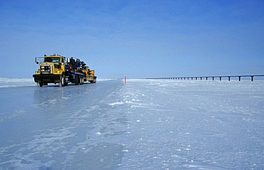 Truck driving on an ice road, built by oil companies and used to connect individual oil drilling sites in winter, Prudhoe Bay, Alaska, USA