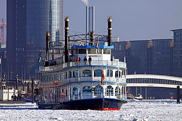 Paddle wheel steamer, Louisiana Star, in winter in the icy waters of the Elbe River in front of HafenCity with the Hanseatic Trade Centre, Hamburg harbour, Hamburg, Germany, Europe