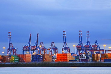 Containers and cranes at the container terminal in last daylight, Hamburg Harbour on Elbe River, Hamburg, Germany