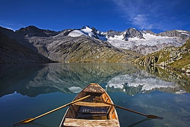 Boat in the lower Gerlossee lake, in front of Reichenspitze peak, Zillertal Alps, North Tyrol, Austria, Europe