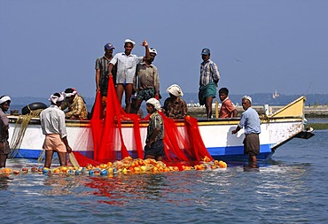 Fishermen fishing on a boat in Kollam, Kerala, India, South Asia