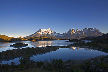 Morning fog and first light at the Torres del Paine massif at the lake Lago Pehoe, national park Torres del Paine, Patagonia, Chlie, South America