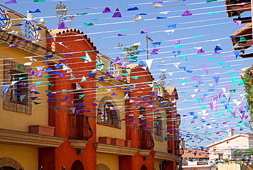 Street with many colourful flags, Pula, Sardinia, Italy