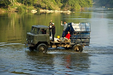 Old lorry drives through water Vang Vieng Laos