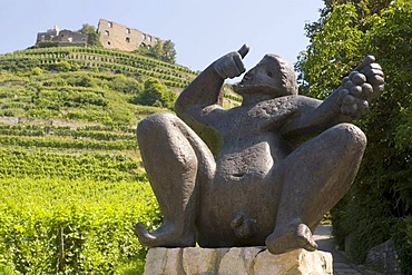 Staufen in the Breisgau Baden-Wurttemberg Baden-Wuettemberg Germany bronce sculpture of the God Bacchus in front of the vine yards around the ruin Staufen