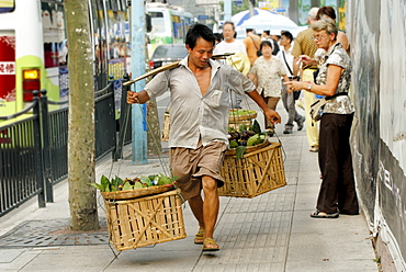 Chinese man with vegetables in baskets, Shanghai, China, Asia