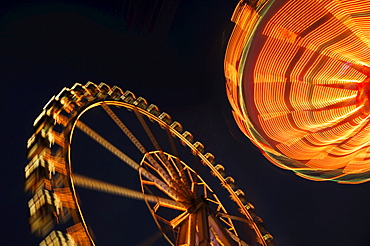 Ferris wheel and swing carousel (chair-o-plane) at a fair in Stuttgart, Baden-Wuerttemberg, Germany, Europe