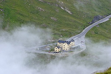 Alpine hotel Glocknerhaus between evening fog Carinthia Austria