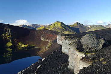 Red scoria and moss the caldera of the Ljotipollur volcano Iceland