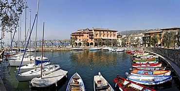 Harbour with sailing ships and small fishing boats, Torri del Benaco, Garda lake, Italy