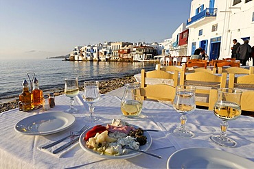 Greec appetizers and the view from a restaurant to Little Venice, Myconos, Greece