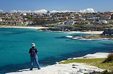 Man watching out over Tamarama and Bronte Beach, Sydney, Australia