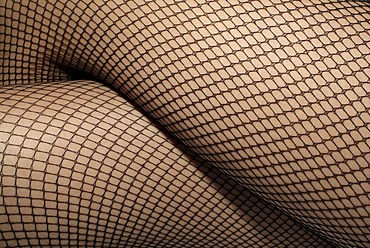 Legs of a woman wearing fishnet stockings