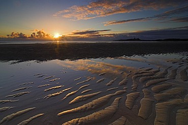 Sunrise at Embleton Bay with Dunstaburgh Castle in the background, Craster, Northumberland, United Kingdom, Europe