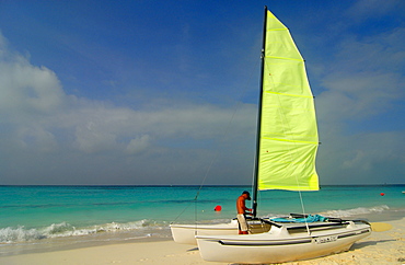 Man with sailboat on the beach at Cayo Largo, Cuba, Americas
