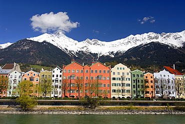 Row of buildings on Mariahilf Street along the Inn River, snow covered Karwendel Mountain Range of the Alps at back, Historic centre of Innsbruck, Inntal Valley, Tyrol, Austria, Europe