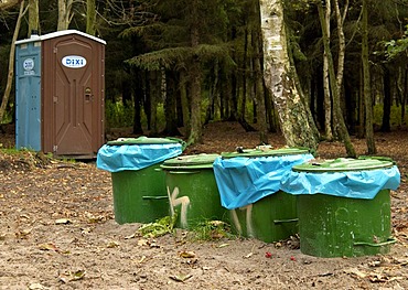 Green dust bins and transportable Dixi toilet in the forest of the National Park Vorpommersche Boddenlandschaft in Mecklenburg Vorpommern, Germany