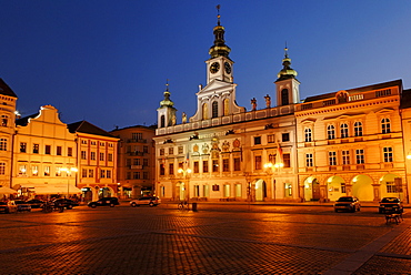 Clock tower over illuminated, floodlit old buildings in the historic centre of Ceske Budejovice, Budweis, South Bohemia, Czech Republic, Czechia, Europe