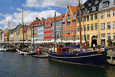 Historic boats in front of a row of apartment houses in the Nyhavn, Copenhagen, Denmark, Scandinavia, Europe