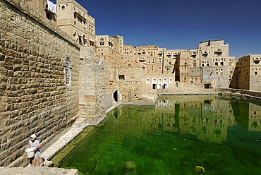 Arabian girl fetching water from the Cistern in Habbaba, Yemen, Arabia, Arab peninsula, the Middle East