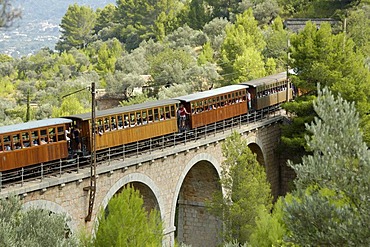 Historic railway train "red flash" on bridge, Soller, Majorca, Spain