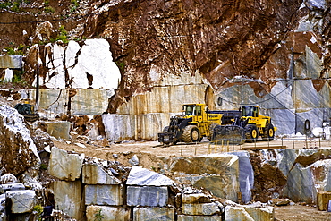 Mechanical shovel excavator in the marble stone pit of Carrara Tuscany Italy