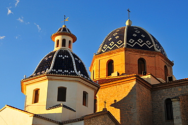 Tiled domes of the golden yellow Iglesia de Nuestra Senora del Consuelo Church, Altea, Costa Blanca, Spain