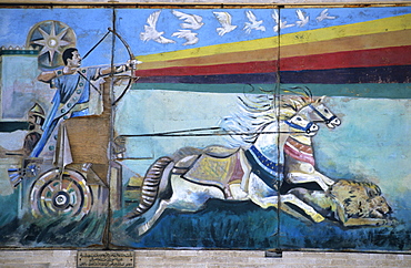 Wall mural depicting Saddam Hussein shooting an arrow from a bow while riding down a lion from a Roman war chariot, painting since destroyed, Mosul, Iraq, Middle East