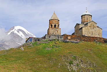 Gergeti Holy Trinity Church in front of the snow-covered back-drop of the 5047m Mt. Kasbeg, near Kasbegi, Georgia, Asia