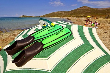 Green flippers on a green sun shade on a beach at Cape Corse, Corsica, France