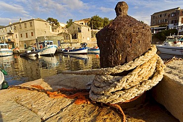 Rusty belayer in the harbour of Centuri, Corsica, France