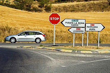 A Renault Laguna estate car is driving past a well signposted crossing, Navarra, Spain