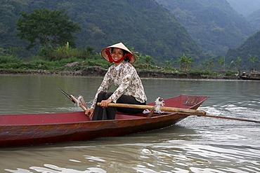 Rowing woman on the Perfume River Vietnam