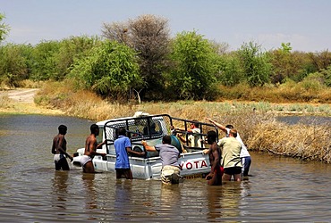 Four-wheel drive jeep booged down while crossing a river, teamwork, Botswana, Africa