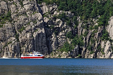 Ship navigating along rock face, Lysefjord, Rogaland, Norway