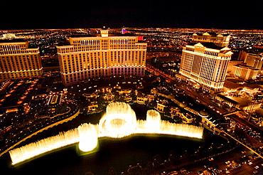 Nighttime aerial view of the fountain in front of the Bellagio and Caesars Palace Hotels and Casinos, Las Vegas, Nevada, USA