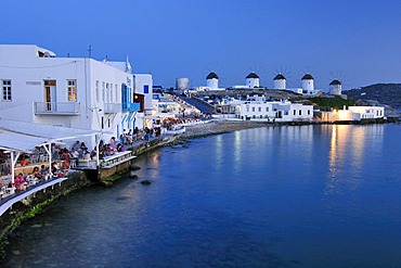 Tourists seated at restaurants in Little Venice, windmills, evening mood, Mykonos Island, Cyclades, Greece, Europe