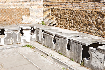 Ancient public toilets at Ostia Antica archaeological site, Rome, Italy, Europe