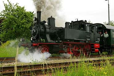 Historical steam train pulling a carriage