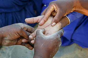 Traditional healer reading the palm of a sick patient, Sehitwa, Botswana, Africa