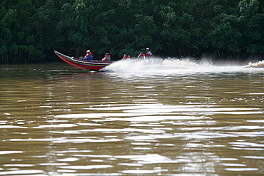 Speedboat carrying passengers, Demerara River, Georgetown, Guyana, South America