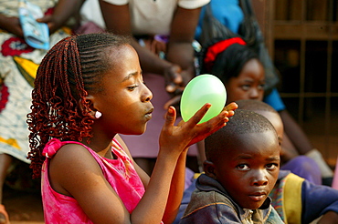 Girl holding balloon, Cameroon, Africa