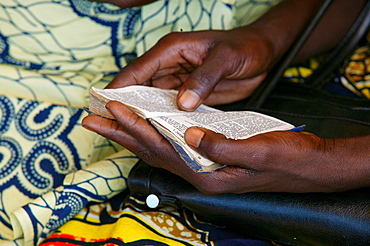 Hands holding a hymn book at a church service, Garoua, Cameroon, Africa