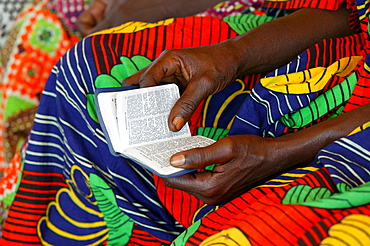 Hands holding a hymn book at a church service, Garoua, Cameroon, Africa