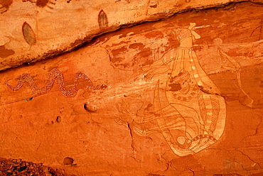 Old rock art of the Aborigines, hunting Kangaroos with a spear, south of Alice Springs, Northern Territory, Australia